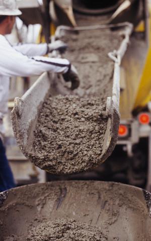 stock-photo-16738579-concrete-from-cement-mixer-trough-for-sidewalk1